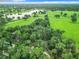 Aerial view of home and surrounding landscape, highlighting the property's serene setting near a lake at 6615 Se 158Th Pl # 6, Summerfield, FL 34491