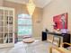 Sunlit home office with chandelier and stylish decor at 6615 Se 158Th Pl # 6, Summerfield, FL 34491