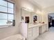 Bathroom with double vanity, large mirror and walk-in shower at 6615 Se 158Th Pl # 6, Summerfield, FL 34491