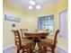 Charming breakfast nook with wood table and four chairs, near a window at 6615 Se 158Th Pl # 6, Summerfield, FL 34491