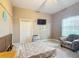Cozy bedroom with a bed, chair, and flat-screen TV at 6615 Se 158Th Pl # 6, Summerfield, FL 34491