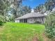 Gray house back with screened porch, spacious lawn, and mature trees at 6615 Se 158Th Pl # 6, Summerfield, FL 34491