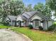 House exterior showcasing a long driveway and landscaping at 6615 Se 158Th Pl # 6, Summerfield, FL 34491