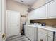 Bright laundry room with washer, dryer, and cabinets at 6615 Se 158Th Pl # 6, Summerfield, FL 34491