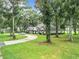 House exterior with a long driveway and green lawn at 6615 Se 158Th Pl # 6, Summerfield, FL 34491
