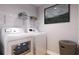Convenient laundry room with washer, dryer, and shelving at Tbd Bay Ct, Ocklawaha, FL 32179