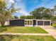 Modern ranch house with gray and white exterior and two-car garage at 4612 Bradley Ave, Orlando, FL 32839