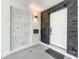 Modern entryway with dark wood accent wall and white door at 4612 Bradley Ave, Orlando, FL 32839