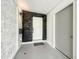 Modern entryway with dark wood accent wall and white door at 4612 Bradley Ave, Orlando, FL 32839