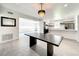 Open concept dining area with kitchen view and modern chandelier at 4612 Bradley Ave, Orlando, FL 32839