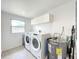 Clean laundry room with Whirlpool washer and dryer at 4612 Bradley Ave, Orlando, FL 32839