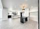 Open concept dining area with kitchen and modern chandelier at 4612 Bradley Ave, Orlando, FL 32839