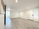 Bright basement with grey flooring, barn door, and lots of natural light at 4612 Bradley Ave, Orlando, FL 32839