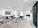 Living room with grey sofa, coffee table, and views into the kitchen at 4612 Bradley Ave, Orlando, FL 32839