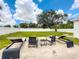 Large backyard with lawn, patio furniture, and sand at 4612 Bradley Ave, Orlando, FL 32839