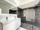 Modern bathroom with double vanity and large dark tile shower at 4612 Bradley Ave, Orlando, FL 32839