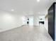 Open living room with grey flooring and views into the kitchen at 4612 Bradley Ave, Orlando, FL 32839