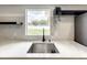 Modern kitchen sink with marble countertop and a window overlooking backyard at 4612 Bradley Ave, Orlando, FL 32839