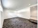 Bright spare bedroom with grey carpet and door to another room at 4612 Bradley Ave, Orlando, FL 32839