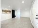 Spacious basement with grey flooring, barn door, and neutral walls at 4612 Bradley Ave, Orlando, FL 32839