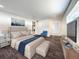 Main bedroom with plush bed, blue chair and large window at 4612 Bradley Ave, Orlando, FL 32839