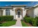 Inviting front entrance with columns, arched entryway and well-manicured landscaping at 2260 Nw 51St Ter, Ocala, FL 34482