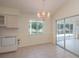 Bright dining area with tile floor, chandelier, and access to a screened patio at 2260 Nw 51St Ter, Ocala, FL 34482