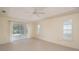 Main bedroom with tile floors, sliding glass doors, and plantation shutters at 2260 Nw 51St Ter, Ocala, FL 34482