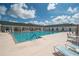 Community pool with lounge chairs and tables at 2260 Nw 51St Ter, Ocala, FL 34482