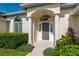 Inviting front entrance with columns, arched entryway and well-manicured landscaping at 2260 Nw 51St Ter, Ocala, FL 34482