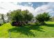Landscaped backyard featuring a screened patio and various shrubs at 2260 Nw 51St Ter, Ocala, FL 34482