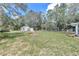 Large grassy backyard with shed and firepit at 1870 Sw Valencia Heights Ave, Dunnellon, FL 34431