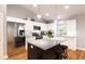 Modern kitchen with stainless steel appliances and kitchen island with seating at Tbd Magnolia Place Dr, Ocklawaha, FL 32179