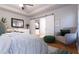Main bedroom with sliding barn doors, a cozy chair, and natural light at Tbd Magnolia Place Dr, Ocklawaha, FL 32179
