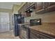 Kitchen with dark wood cabinets, granite countertops, and stainless steel appliances at 12789 Sw 86Th Cir, Ocala, FL 34473
