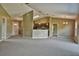 Open living room with high ceilings, carpet, and access to kitchen and backyard at 12789 Sw 86Th Cir, Ocala, FL 34473
