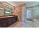 Bathroom with a large vanity, soaking tub, and neutral color palette at 12789 Sw 86Th Cir, Ocala, FL 34473