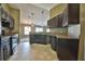 Modern kitchen with dark wood cabinets, granite countertops, and stainless steel appliances at 12789 Sw 86Th Cir, Ocala, FL 34473