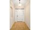 Front entry with a white door and tile flooring at 16292 Sw 13Th Ter, Ocala, FL 34473