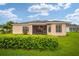 House exterior showcasing a screened patio and landscaping at 16292 Sw 13Th Ter, Ocala, FL 34473