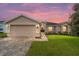 One-story house with a beige exterior and brick driveway at 16292 Sw 13Th Ter, Ocala, FL 34473