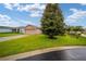 House exterior showcasing a well-maintained lawn and tree at 16292 Sw 13Th Ter, Ocala, FL 34473