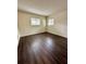 Bedroom with dark laminate wood flooring and large windows at 2851 Sw 32Nd Ave # 12, Ocala, FL 34474