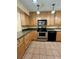 Kitchen with light wood cabinets, stainless steel appliances, and tile floors at 2851 Sw 32Nd Ave # 12, Ocala, FL 34474