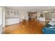 Open living space with hardwood floors, teal sofa, and kitchen access at 9372 Sw 90Th St, Ocala, FL 34481