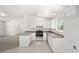 Modern kitchen with stainless steel appliances and grey countertops at 24449 Nw Falcon Ave, Dunnellon, FL 34431