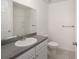 Clean bathroom with gray countertop, white cabinets and shower/tub combo at 24449 Nw Falcon Ave, Dunnellon, FL 34431