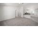 Bright living room with grey carpet and access to kitchen and bedrooms at 24449 Nw Falcon Ave, Dunnellon, FL 34431