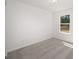 Simple bedroom with gray carpet, neutral walls, and a window at 24449 Nw Falcon Ave, Dunnellon, FL 34431