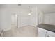 Simple dining area with light wood flooring and kitchen access at 24449 Nw Falcon Ave, Dunnellon, FL 34431